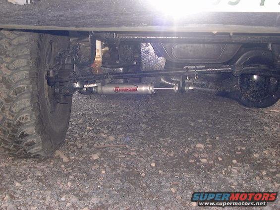 Steering stabilizer with 'Rancho' text on vehicle's front axle